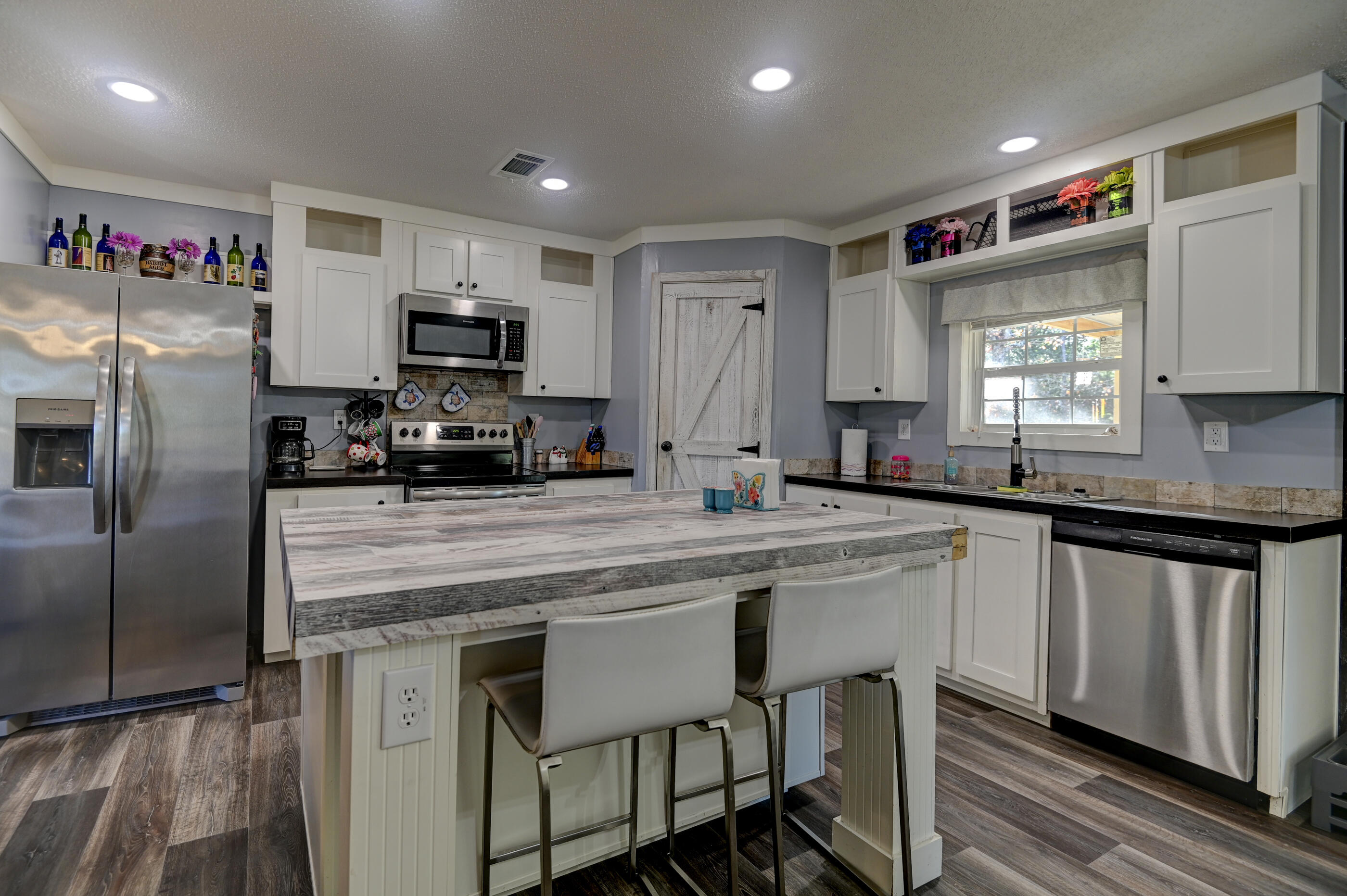 5256 Mt Olive Road Crestview, FL 32539 - Photo 17 of 68 a kitchen with stainless steel appliances granite countertop a sink a stove a refrigerator cabinets and a refrigerator