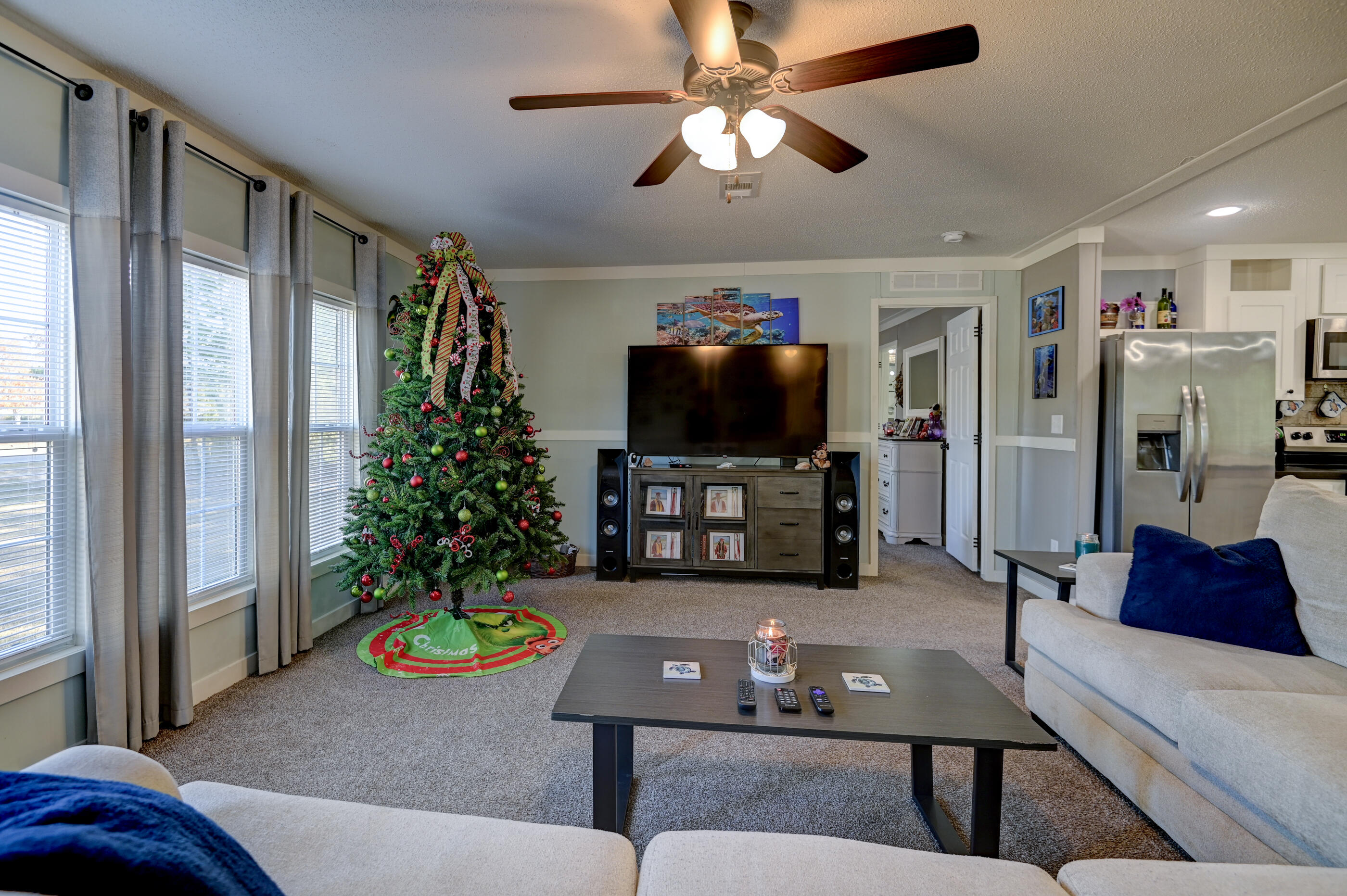 5256 Mt Olive Road Crestview, FL 32539 - Photo 20 of 68 a living room with furniture a chandelier and a flat screen tv