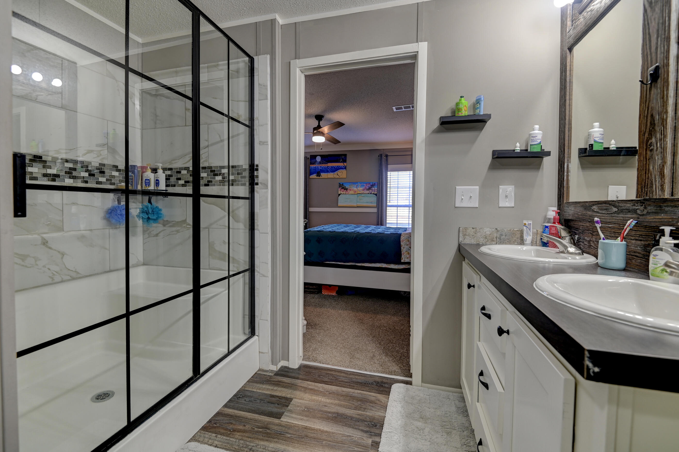 5256 Mt Olive Road Crestview, FL 32539 - Photo 33 of 68 a en suite bathroom with a double vanity sink and a mirror