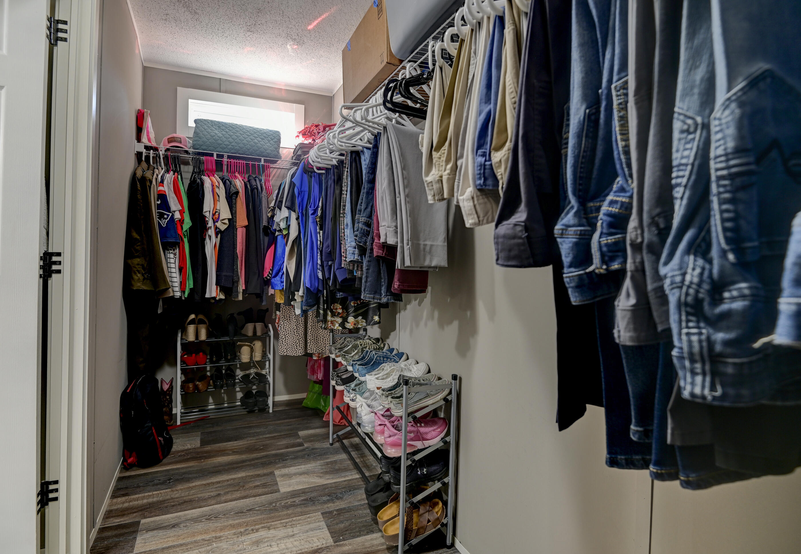5256 Mt Olive Road Crestview, FL 32539 - Photo 35 of 68 a view of walk in closet with clothes and shoes