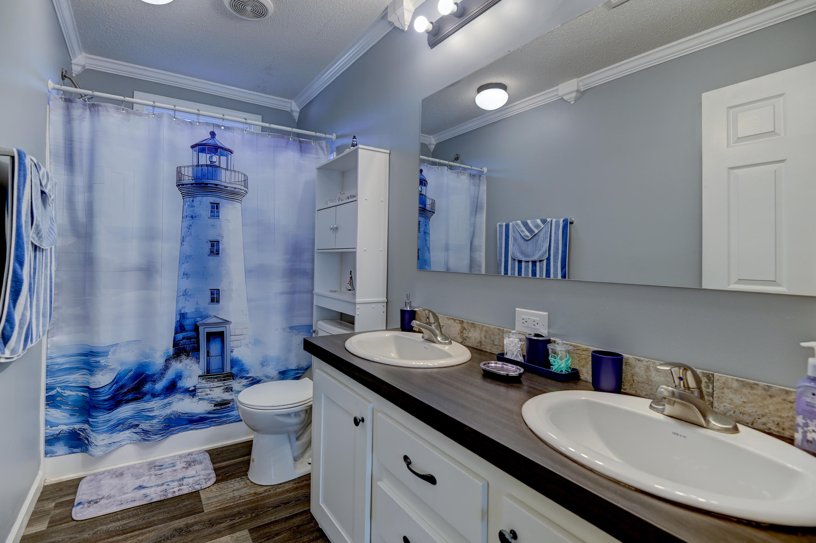 5256 Mt Olive Road Crestview, FL 32539 - Photo 41 of 68 a bathroom with double vanity sinks a mirror and a shower