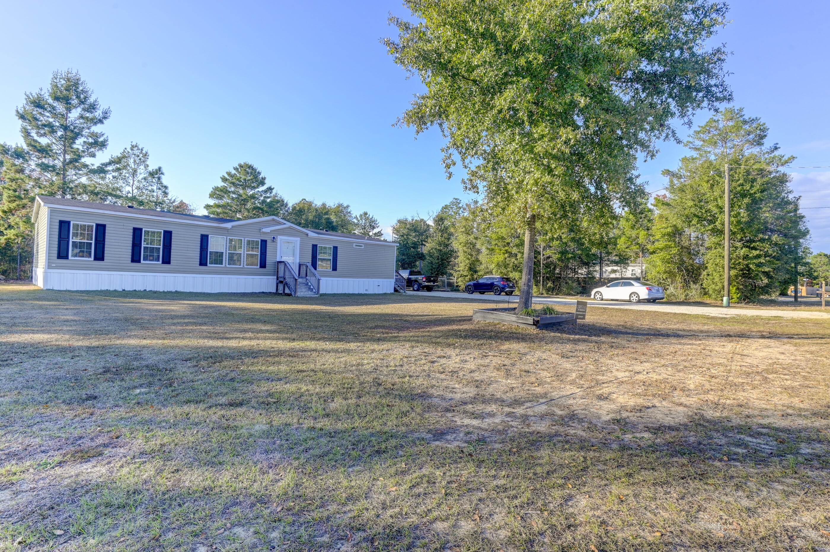 5256 Mt Olive Road Crestview, FL 32539 - Photo 63 of 68 a house with lots of trees in the background