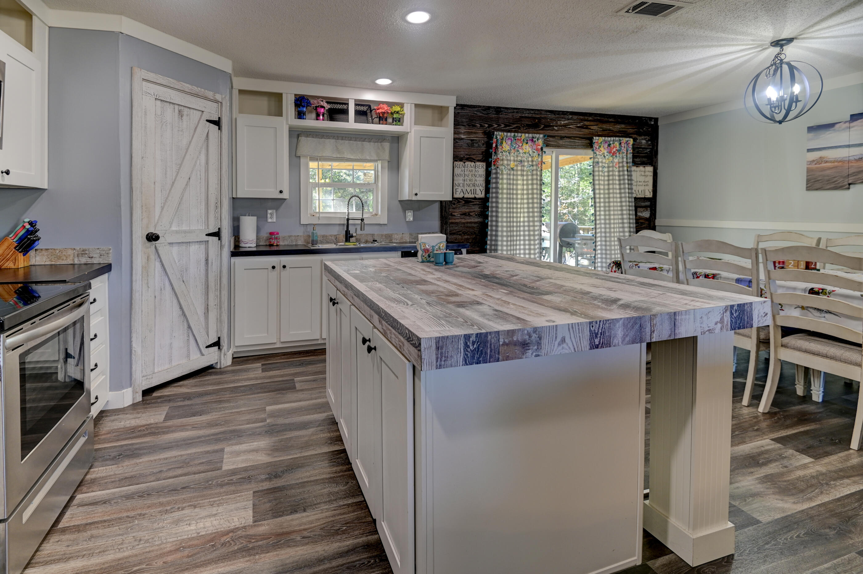 5256 Mt Olive Road Crestview, FL 32539 - Photo 7 of 68 a kitchen with stainless steel appliances granite countertop a stove a sink and a refrigerator