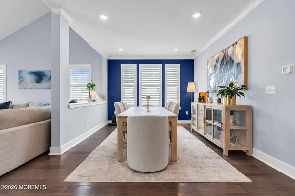 a living room with furniture and kitchen view