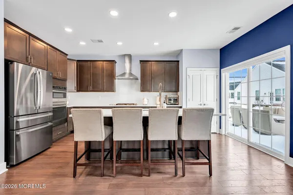 a kitchen with kitchen island wooden cabinets and stainless steel appliances