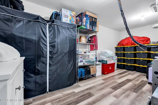 a living room with furniture kitchen view and a chandelier