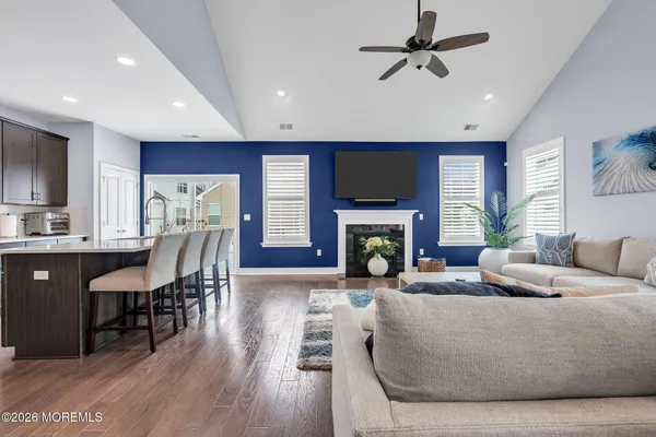 a living room with furniture a fireplace and a flat screen tv