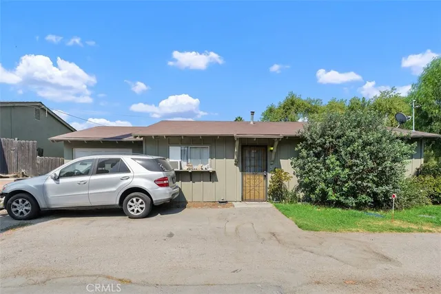 a front view of a house with parking space