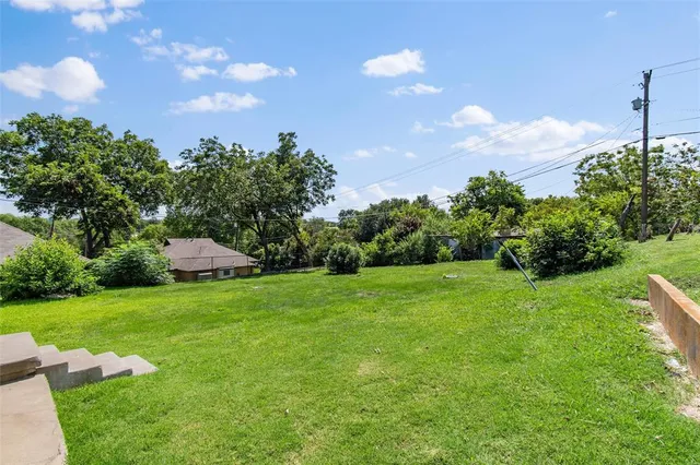 a backyard of a house with lots of green space
