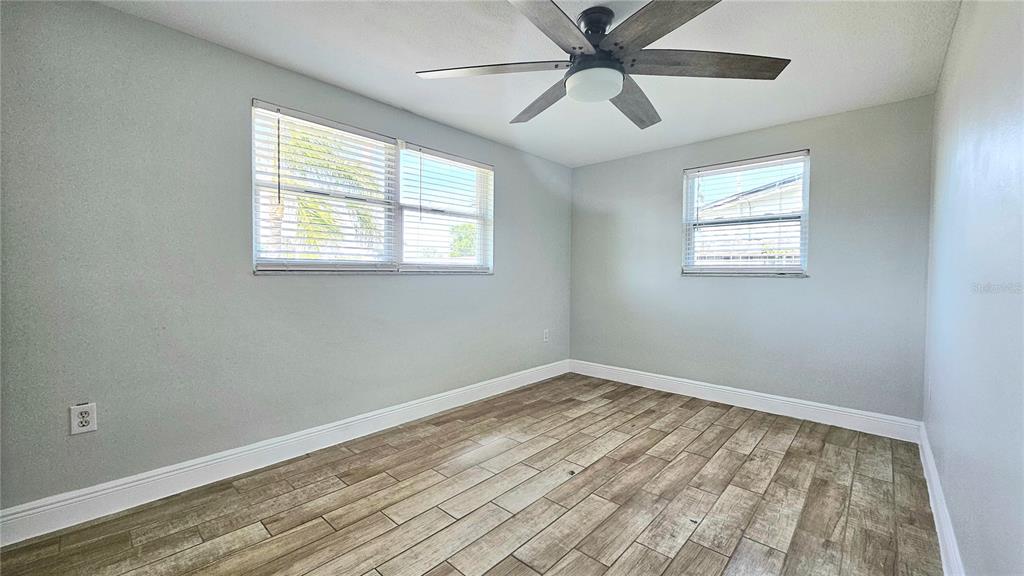 6412 Pawling Avenue Port Richey, FL 34668 - Photo 11 of 24 a view of empty room with wooden floor and fan