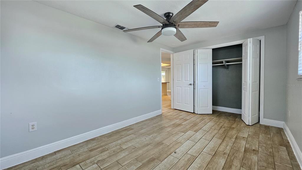 6412 Pawling Avenue Port Richey, FL 34668 - Photo 13 of 24 wooden floor in an empty room with a window