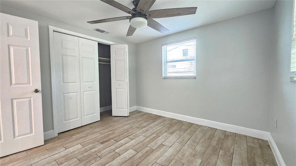 6412 Pawling Avenue Port Richey, FL 34668 - Photo 16 of 24 wooden floor in an empty room with a window