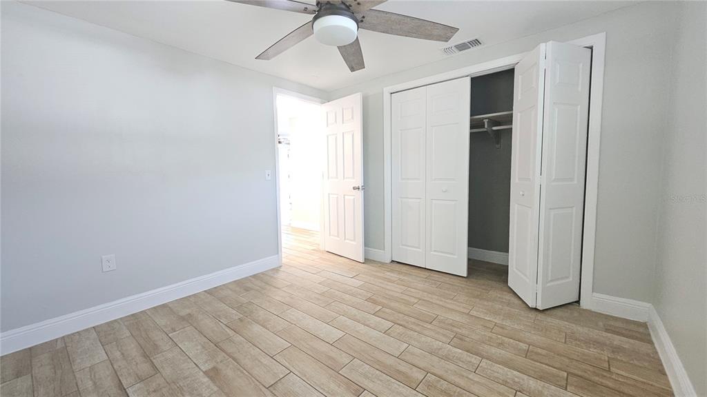 6412 Pawling Avenue Port Richey, FL 34668 - Photo 17 of 24 a view of an empty room with window and wooden floor