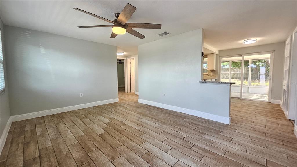 6412 Pawling Avenue Port Richey, FL 34668 - Photo 4 of 24 an empty room with wooden floor and windows