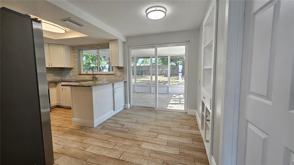 6412 Pawling Avenue Port Richey, FL 34668 - Photo 6 of 24 a open kitchen with granite countertop a stove and a sink