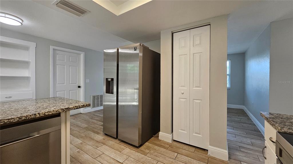 6412 Pawling Avenue Port Richey, FL 34668 - Photo 9 of 24 a kitchen with stainless steel appliances granite countertop a refrigerator and a sink