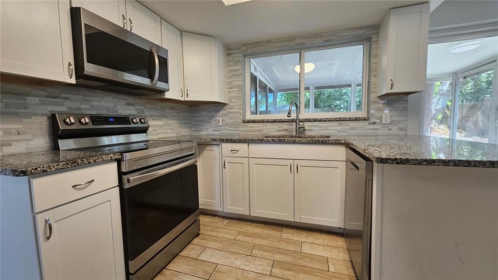 6412 Pawling Avenue Port Richey, FL 34668 - Photo 10 of 24 a kitchen with appliances cabinets and a sink