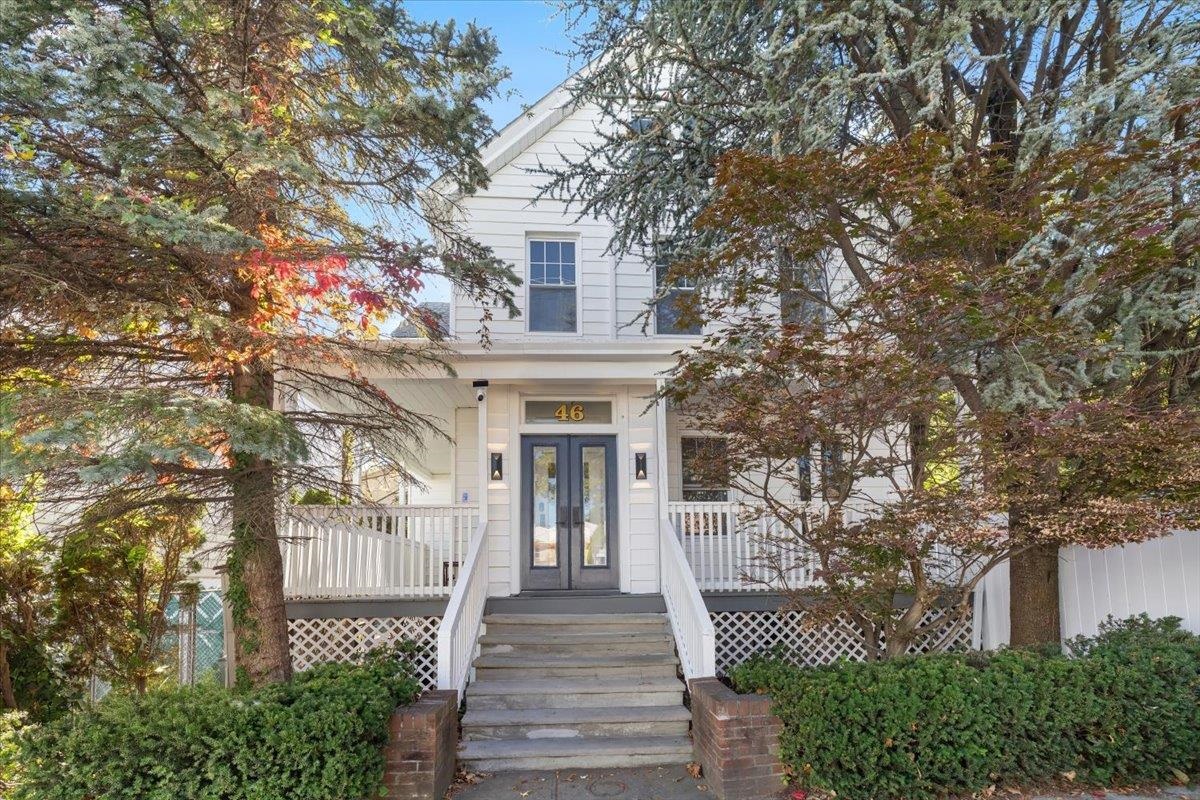 a front view of a house with a garden