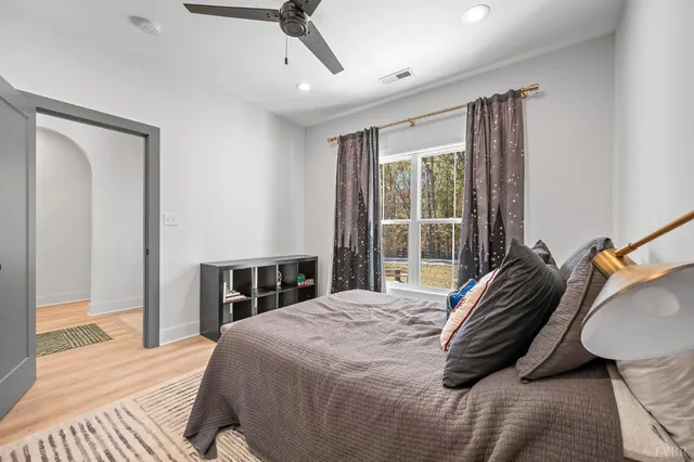 a bedroom with a bed and wooden floor