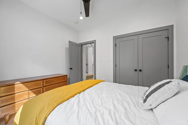 a bedroom with a bed and a chandelier