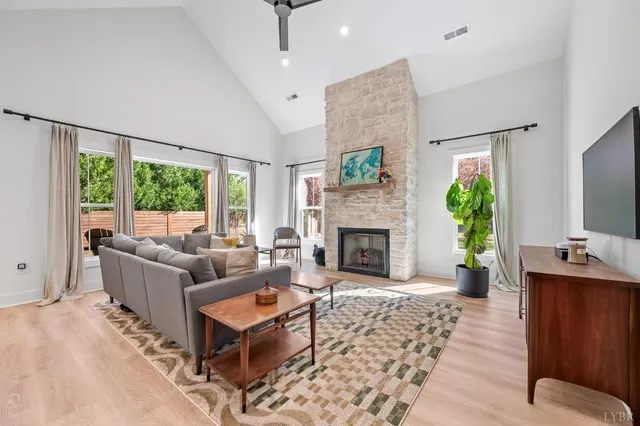 a living room with furniture fireplace and window