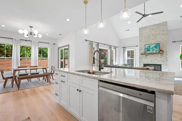 a kitchen with lots of counter space dining table and a chandelier