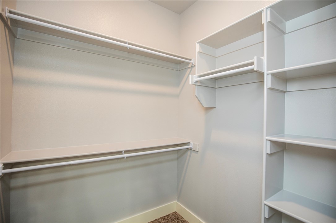 214 Alder Street Pea Ridge, AR 72751 - Photo 17 of 20 Walk-in closet with integrated shelving and multiple hanging rods
