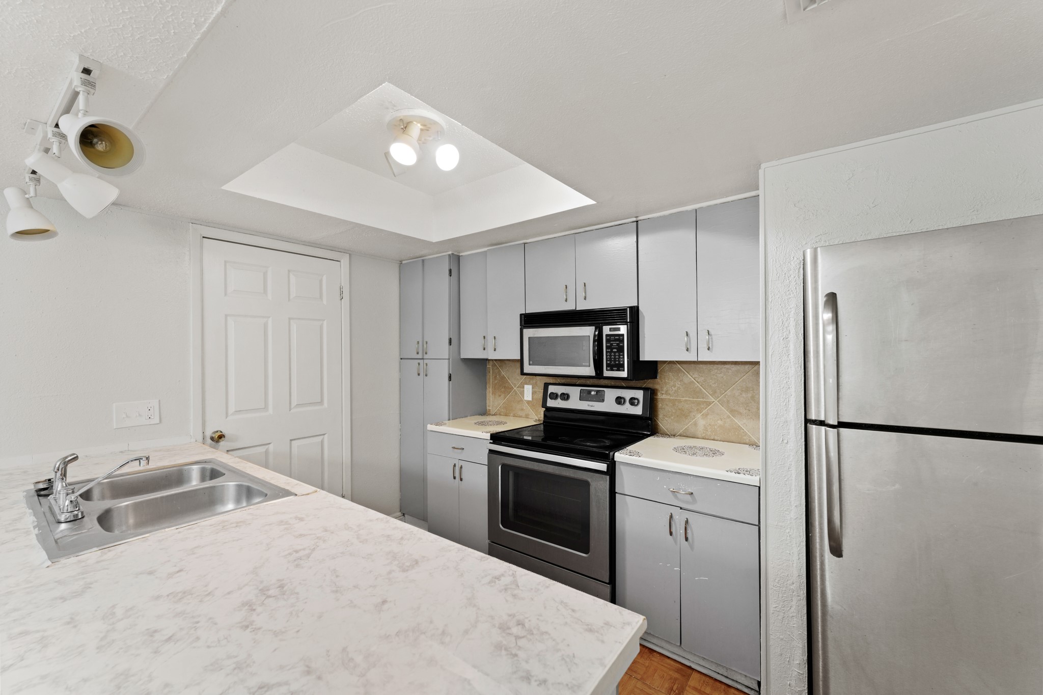 5715 Easthampton Drive, Unit A Houston, TX 77039 - Photo 2 of 6 a kitchen with a sink a stove and refrigerator