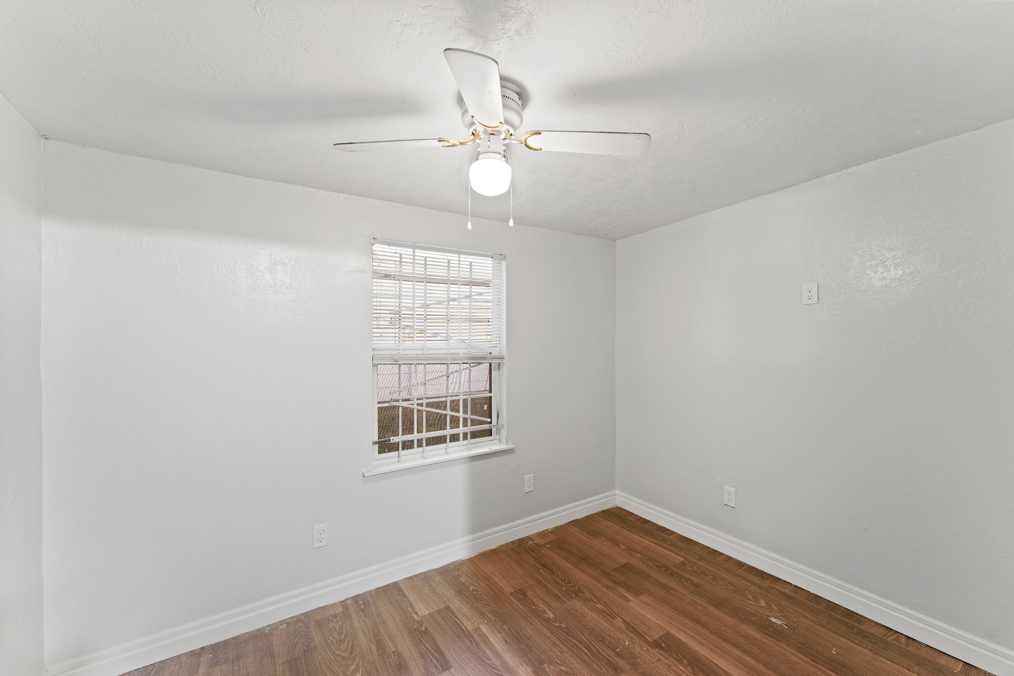 5715 Easthampton Drive, Unit A Houston, TX 77039 - Photo 4 of 6 an empty room with wooden floor fan and windows