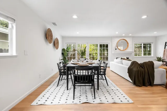 a view of a dining room with furniture window and wooden floor
