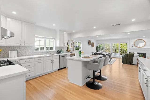 a kitchen with a sink stainless steel appliances and windows