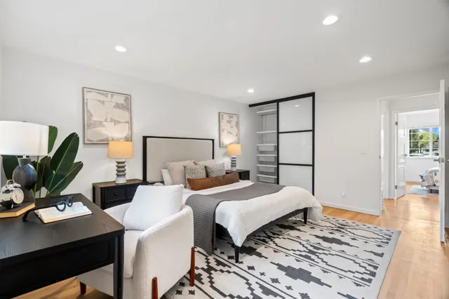 a bedroom with a bed and a desk