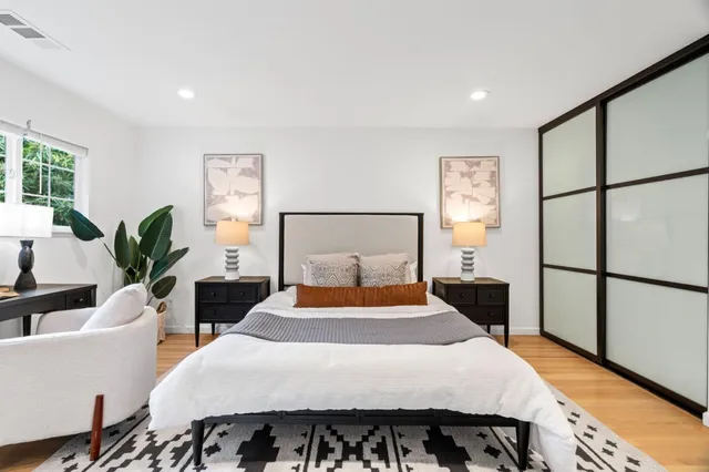 a bedroom with a bed and wooden floor