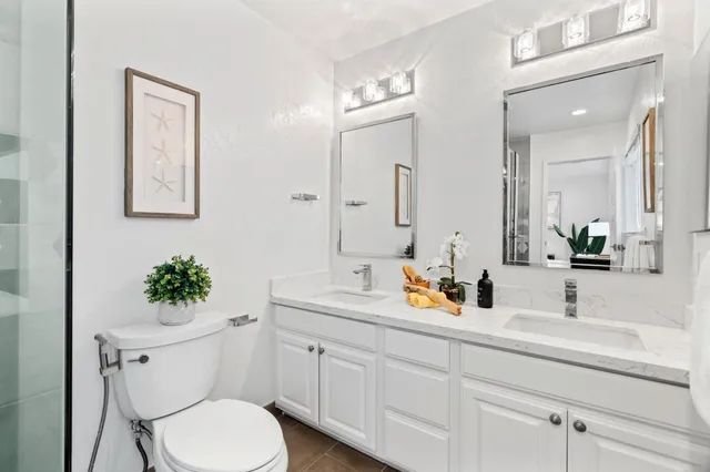 a bathroom with a toilet sink and mirror