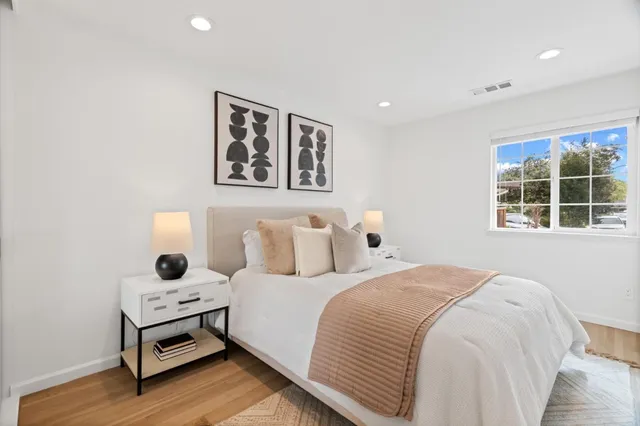 a bedroom with a bed and a window