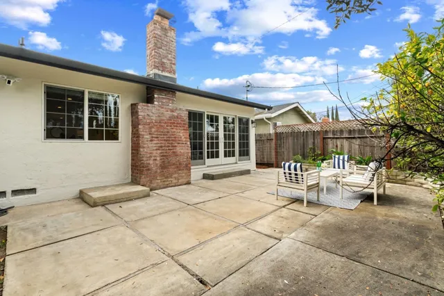 a balcony with furniture and large trees