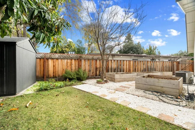 a backyard of a house with table and chairs