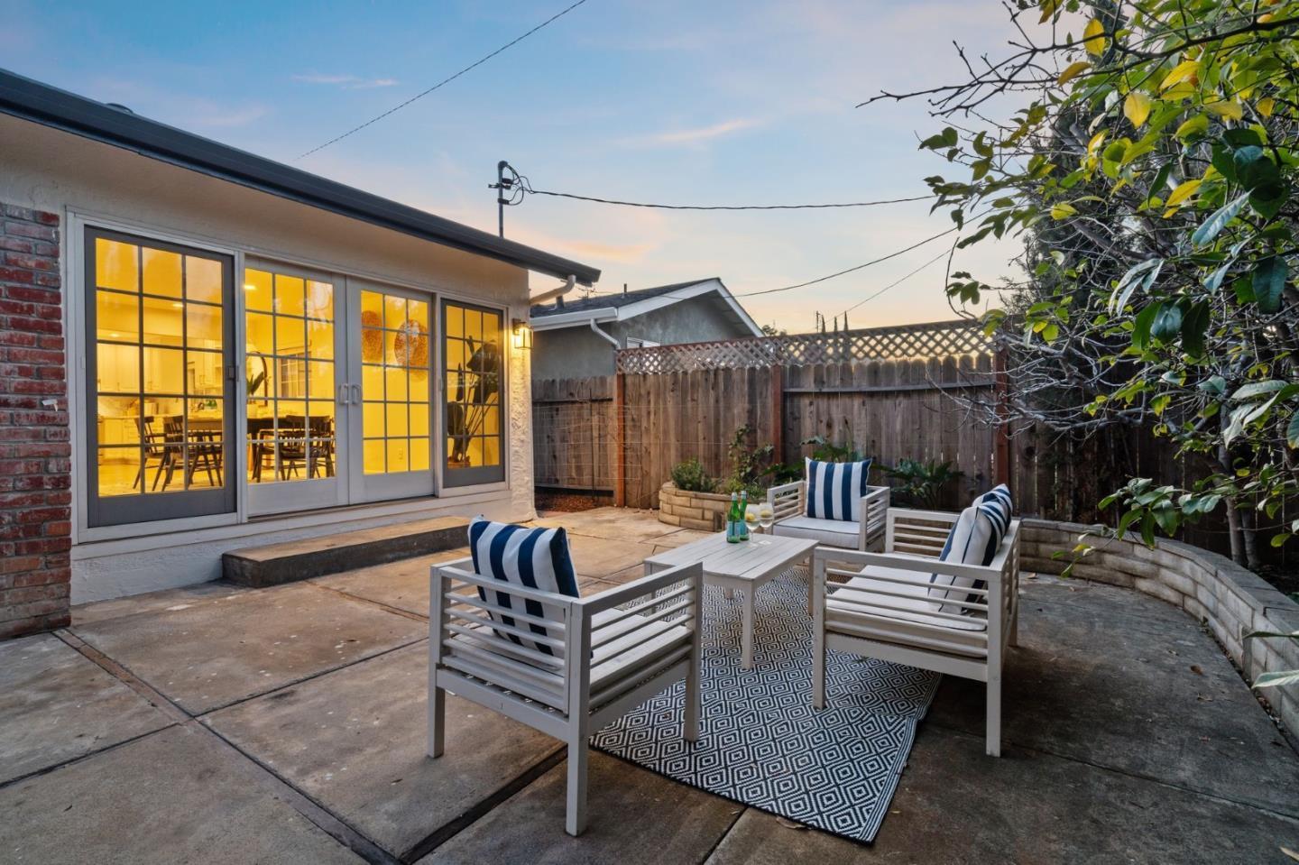1002 Oaktree Drive San Jose, CA 95129 - Photo 40 of 45 a view of a patio with a dining table and chairs with wooden floor