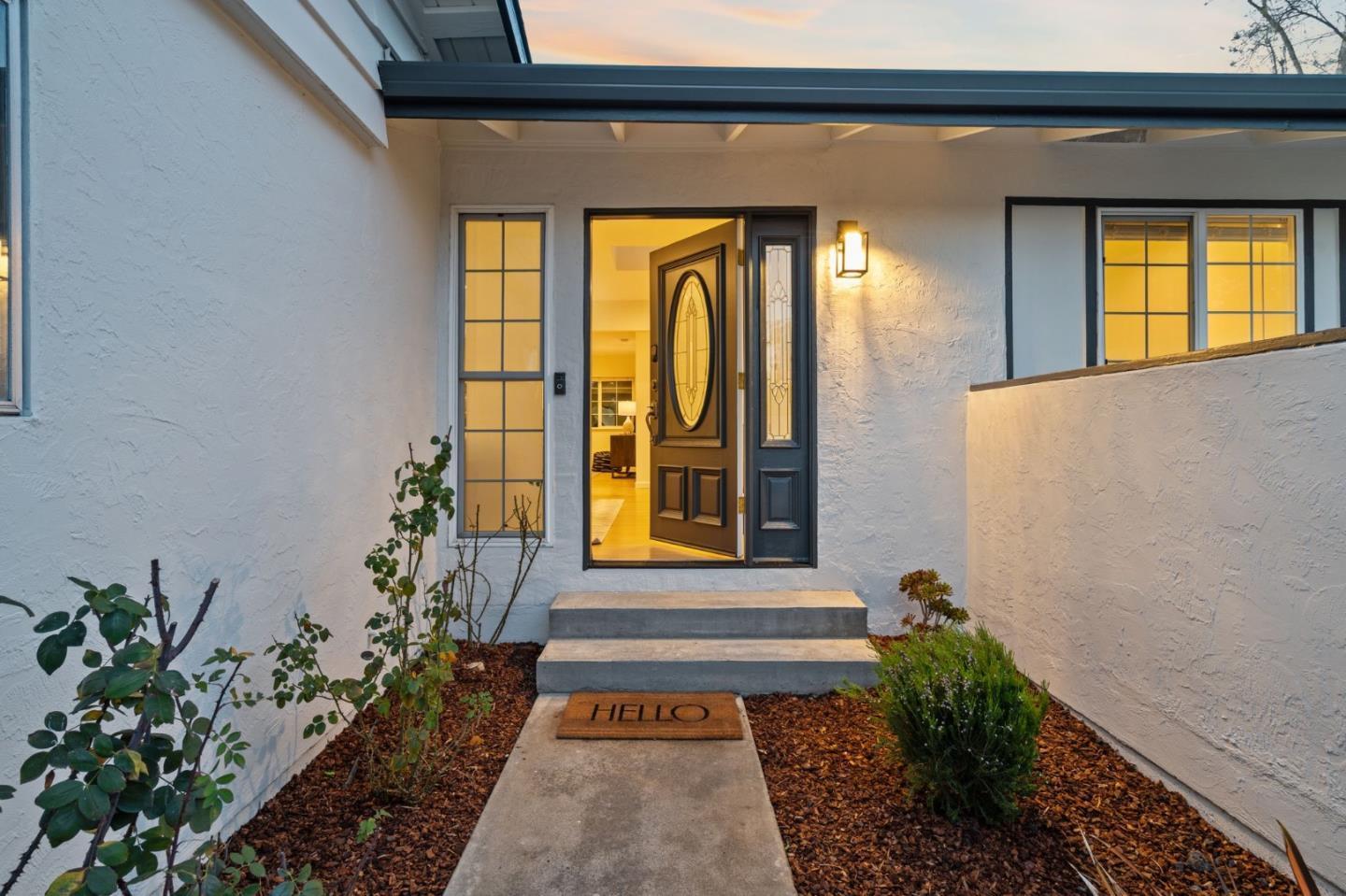 1002 Oaktree Drive San Jose, CA 95129 - Photo 5 of 45 a front view of a house with a yard