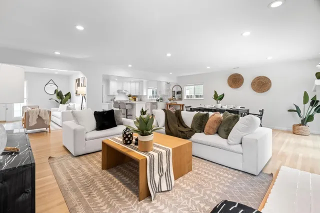 a living room with furniture and kitchen view
