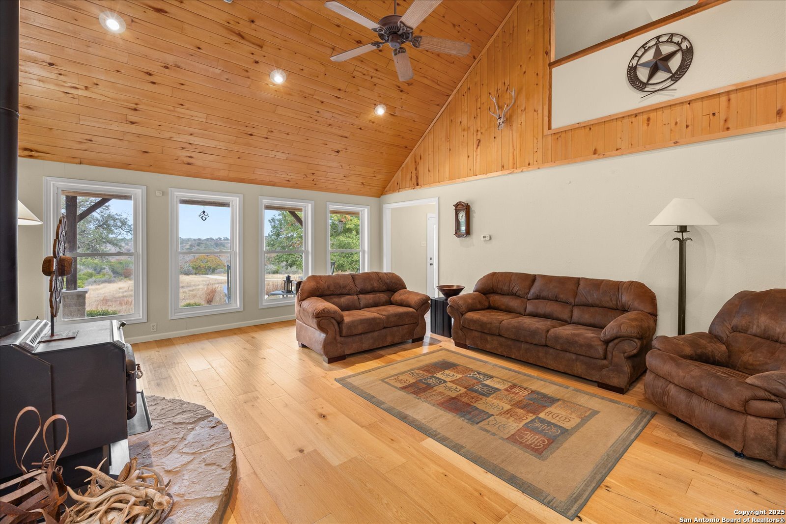 127 Camp Alzafar Road Boerne, TX 78006 - Photo 11 of 50 a living room with furniture ceiling fan and a rug