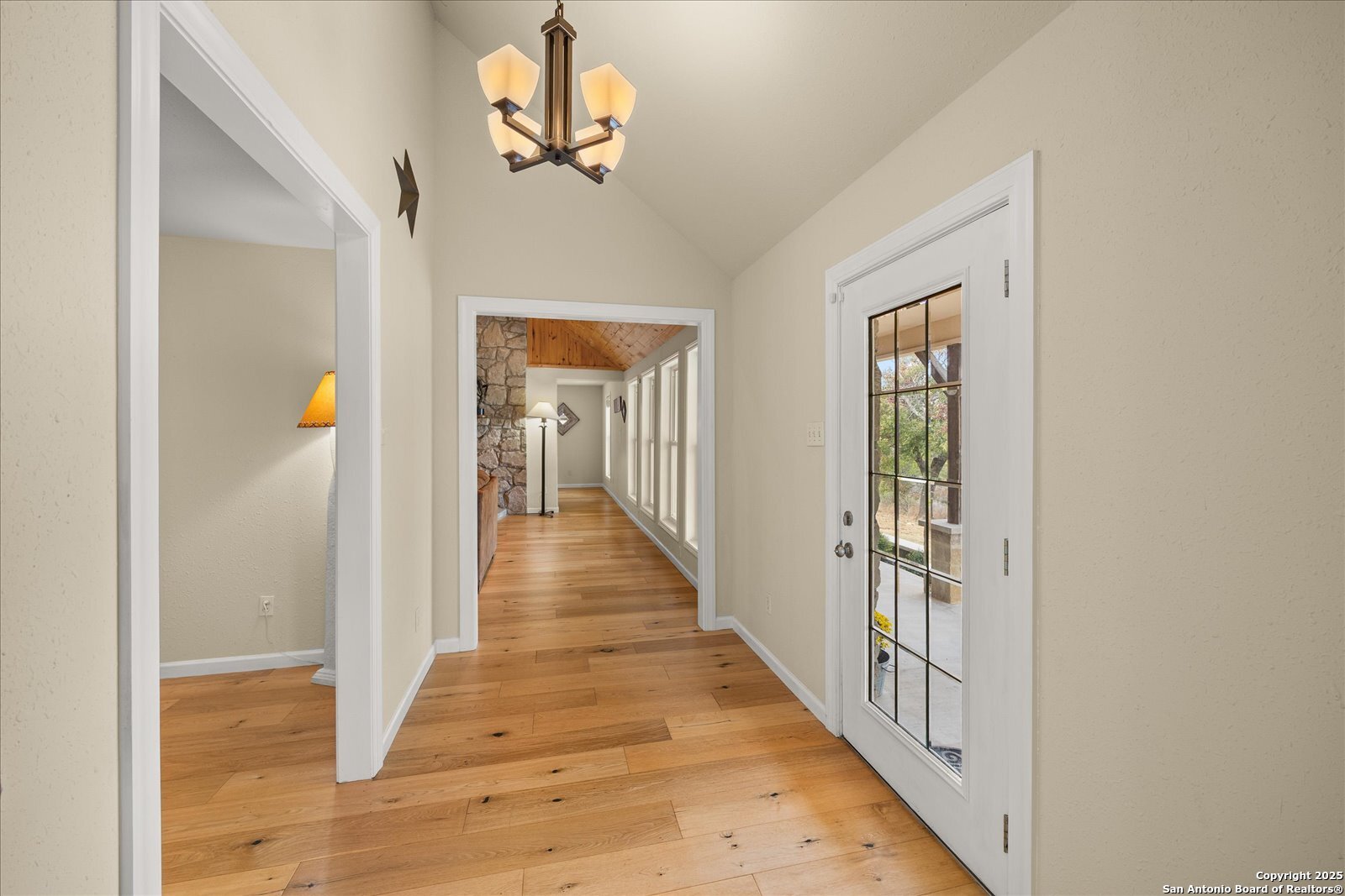 127 Camp Alzafar Road Boerne, TX 78006 - Photo 13 of 50 a view of a hallway with wooden floor and entryway