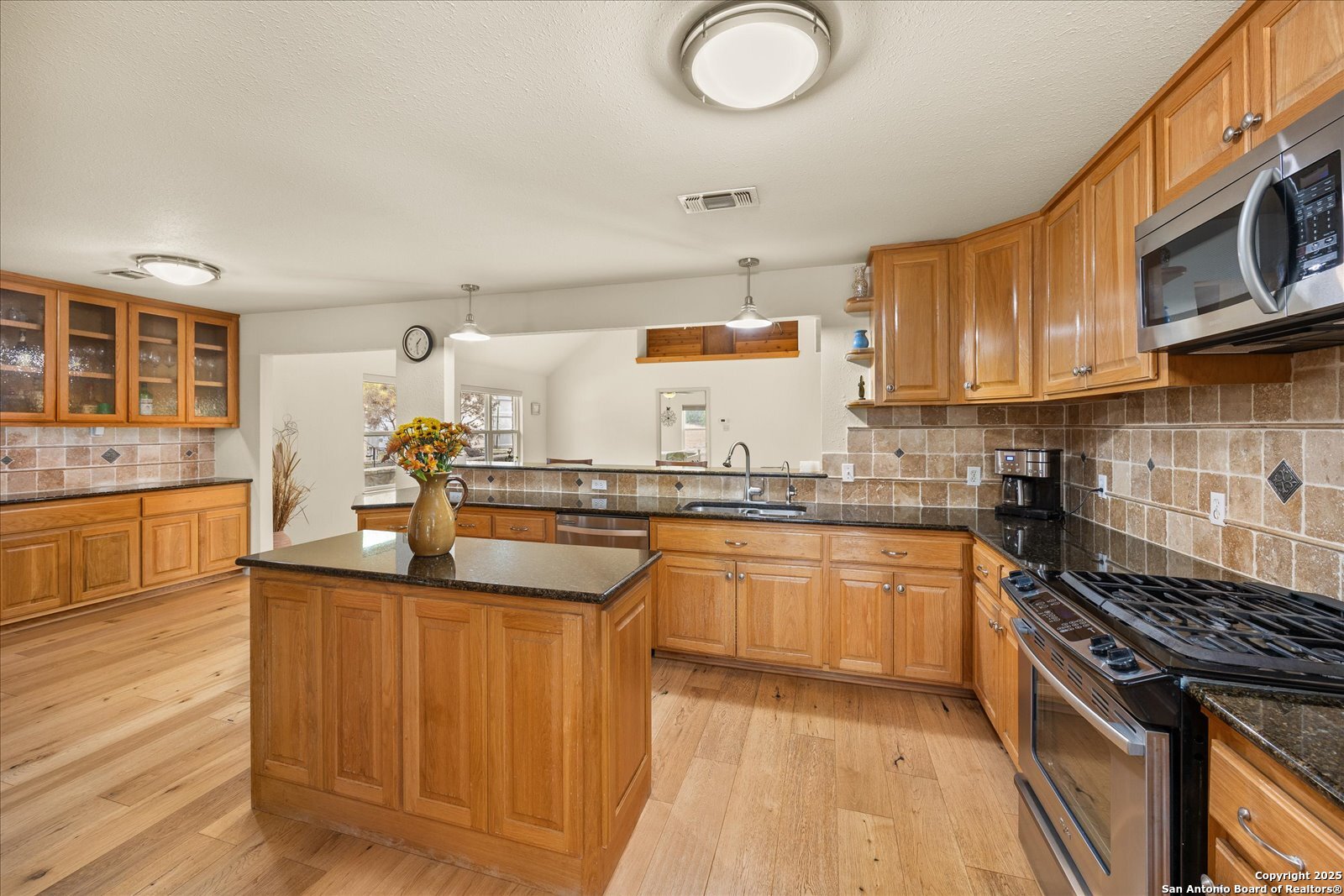 127 Camp Alzafar Road Boerne, TX 78006 - Photo 15 of 50 a kitchen with stainless steel appliances granite countertop a sink stove and cabinets