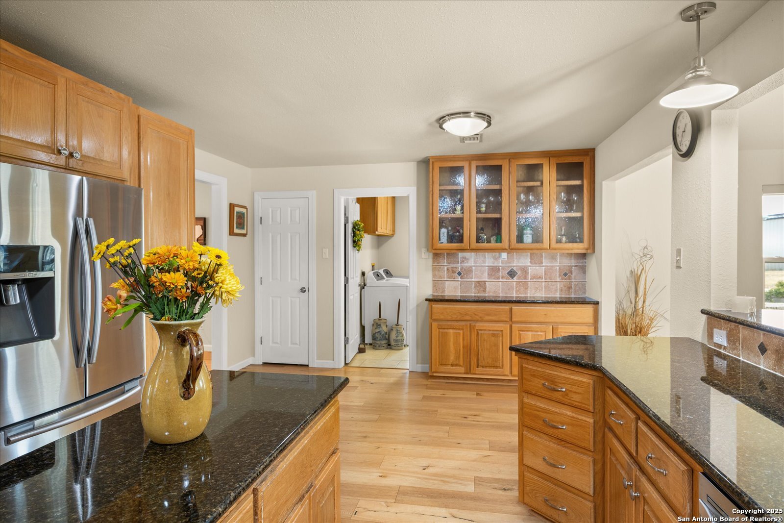 127 Camp Alzafar Road Boerne, TX 78006 - Photo 16 of 50 a kitchen with stainless steel appliances granite countertop a sink stove and refrigerator
