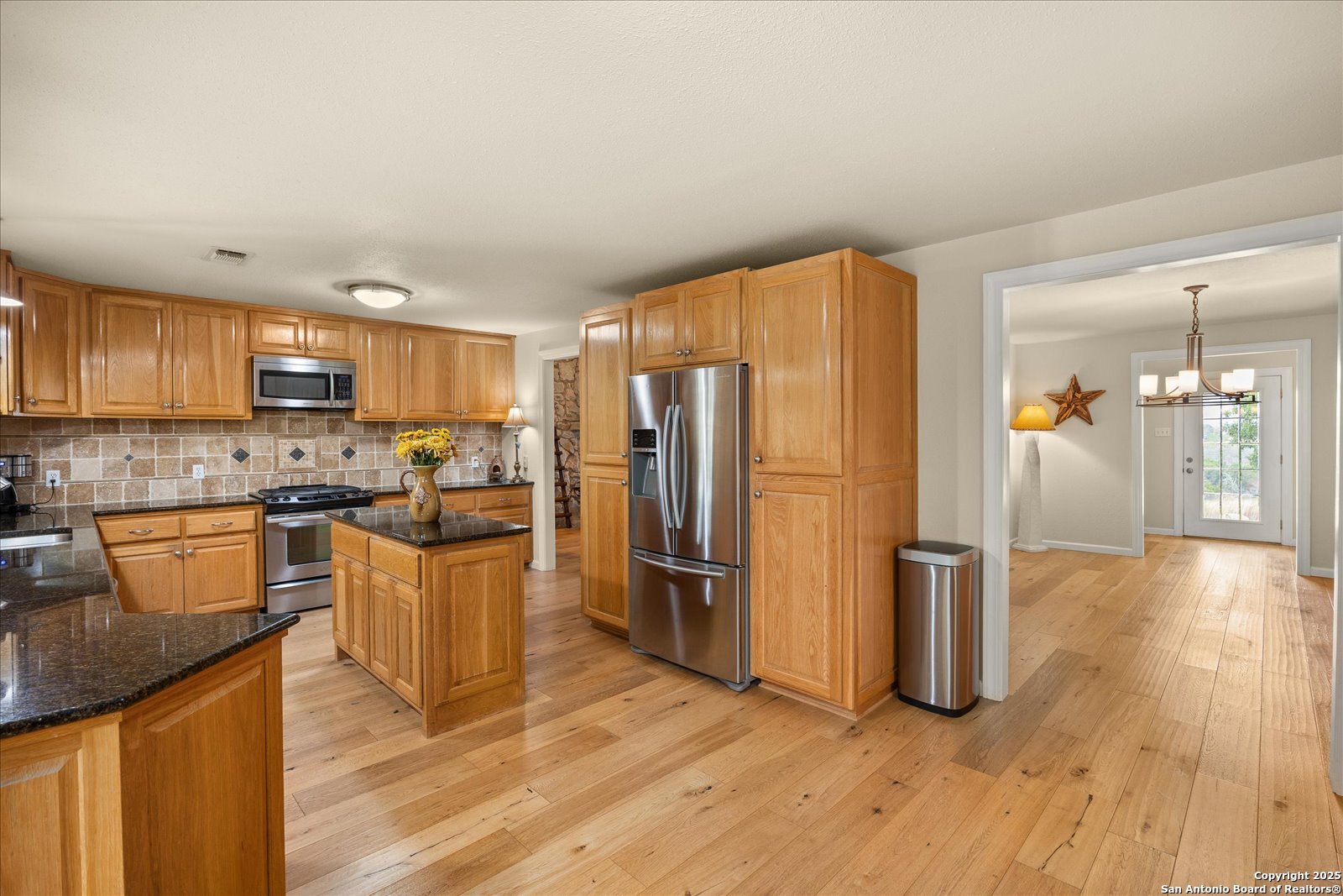 127 Camp Alzafar Road Boerne, TX 78006 - Photo 17 of 50 a kitchen with stainless steel appliances granite countertop a refrigerator stove top oven and sink