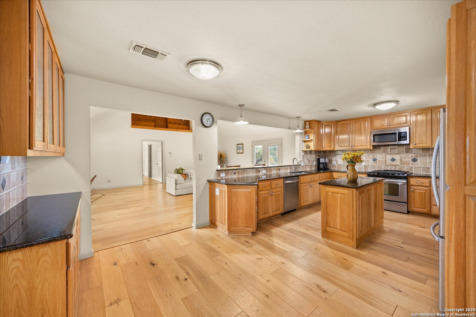 127 Camp Alzafar Road Boerne, TX 78006 - Photo 18 of 50 a kitchen with a refrigerator and a stove top oven