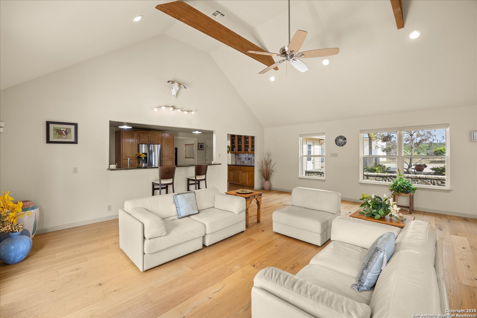 127 Camp Alzafar Road Boerne, TX 78006 - Photo 19 of 50 a living room with furniture and a chandelier