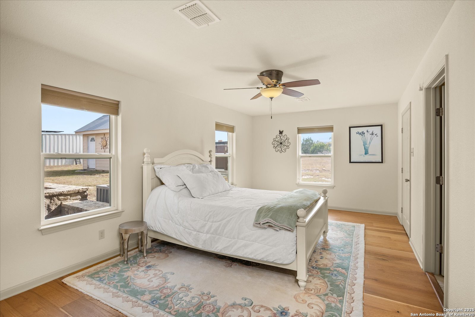 127 Camp Alzafar Road Boerne, TX 78006 - Photo 21 of 50 a bedroom with a bed and a window
