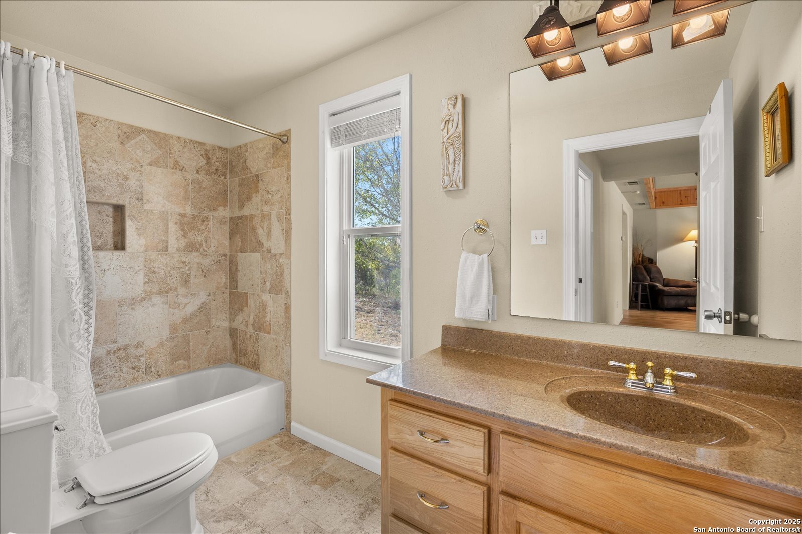127 Camp Alzafar Road Boerne, TX 78006 - Photo 27 of 50 a bathroom with a granite countertop sink toilet mirror and bathtub