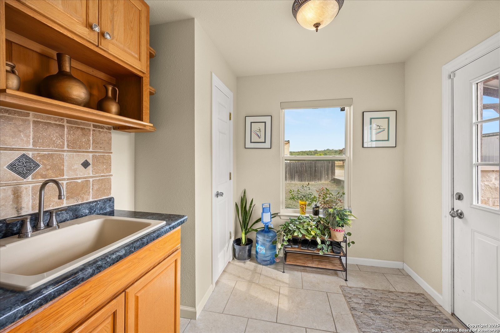127 Camp Alzafar Road Boerne, TX 78006 - Photo 33 of 50 a kitchen with a sink and a refrigerator